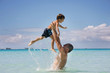 father and son playing in water