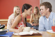 Young Man and woman sharing noodle in cafeteria