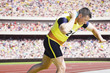 Athlete shot putting in an arena