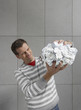 Man squeezing large ball of paper