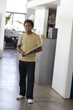 Businessman standing with laptop in office