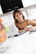 Modern woman reading e-mails at her breakfast