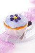 Closeup of cupcakes decorated with candied violets from flower o Closeup of cupcakes decorated with candied violets from flower o