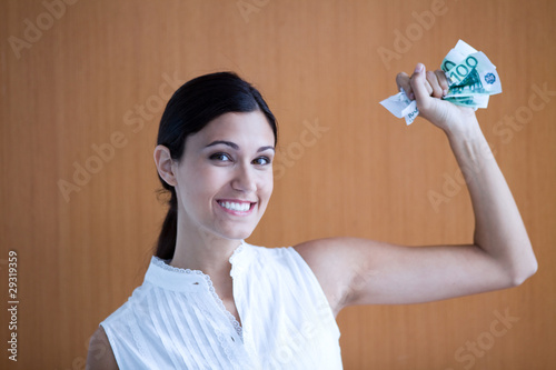Photo: Woman holding money Woman holding money