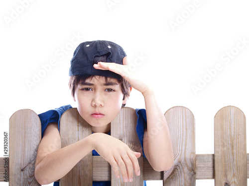 Photo: child looking over a fence child looking over a fence