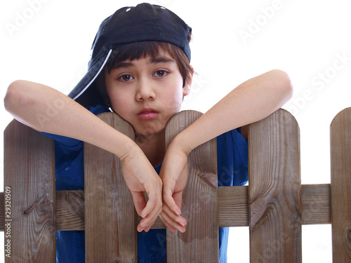 Photo: child looking over a fence child looking over a fence
