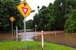 Flooded road with depth indicators and give way sign in Queensla