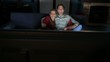 man and woman watching movie on tv