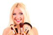 Beautiful young blonde woman with bright make-up and many brushe Beautiful young blonde woman with bright make-up and many brushe