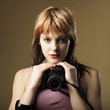 Young beautiful woman taking a photo with a digital camera