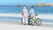 Aged couple walking with bikes
