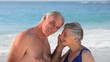 Aged couple listening to a seashell