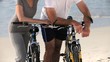 Elderly couple with bikes looking at the beach