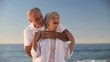 Aged man hugging his wife