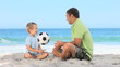 Father and son playing with a soccer ball