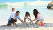 Family building a sand castle
