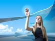 Attractive blonde with interface in futuristic interior Attractive blonde with interface in futuristic interior