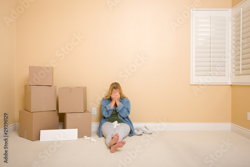 Photo: Upset Woman on Floor Next to Boxes and Blank Sign Upset Woman on Floor Next to Boxes and Blank Sign