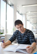 handsome young college student in a library (shallow DOF; color