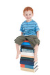 Boy sitting on stack of books Boy sitting on stack of books