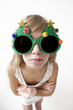 girl wearing big round glasses  making silly expression