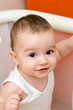 Fun caucasian baby in manege