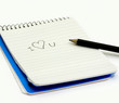 Photo: Pencil and small notebook with a love valentine message Pencil and small notebook with a love valentine message