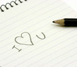 Photo: Pencil and small notebook with a love valentine message Pencil and small notebook with a love valentine message