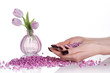 Cupped hands holding stones; vase with tulips on the background