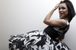 Studio photo of beautiful emotional brunette in classic dress.