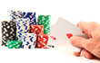 hands of a man with a card and poker chips in the background. hands of a man with a card and poker chips in the background.