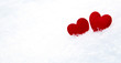 Red hearts on snow