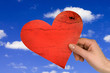 love concept. hand with heart on sky background
