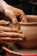 hands of a potter, creating an earthen jar on the circle