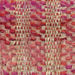 Macro detail of woven mohair shawl in red, pink and beige