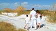 Loving Family Walking on the Beach