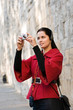 Young woman with headphones, listening to audio guide taking pic Young woman with headphones, listening to audio guide taking pic