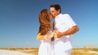 Attractive Couple Enjoying a Kiss on the Beach