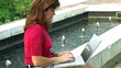 Female Typing by Fountain