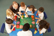 Overhead View Of Schoolchildren Working Together At Desk Overhead View Of Schoolchildren Working Together At Desk