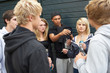 Group Of Threatening Teenagers Hanging Out Together Outside Drin
