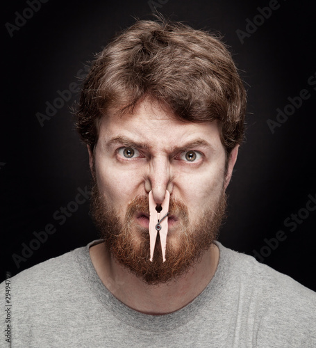 Photo: Bad smell concept - peg on male nose Bad smell concept - peg on male nose