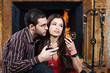 Romantic couple near fireplace drinking red wine Romantic couple near fireplace drinking red wine