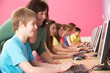 Teenage Students In IT Class Using Computers In Classroom With T