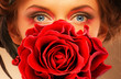 Woman eyes and red rose