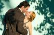 The embracing couple in front of a green background