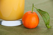 Close-up of an orange with a glass of juice