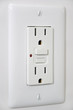 Outlet with secured button