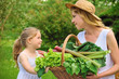 Photo: Young woman and daughter with fresh vegetable Young woman and daughter with fresh vegetable