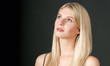Portrait of beautiful young woman on black background